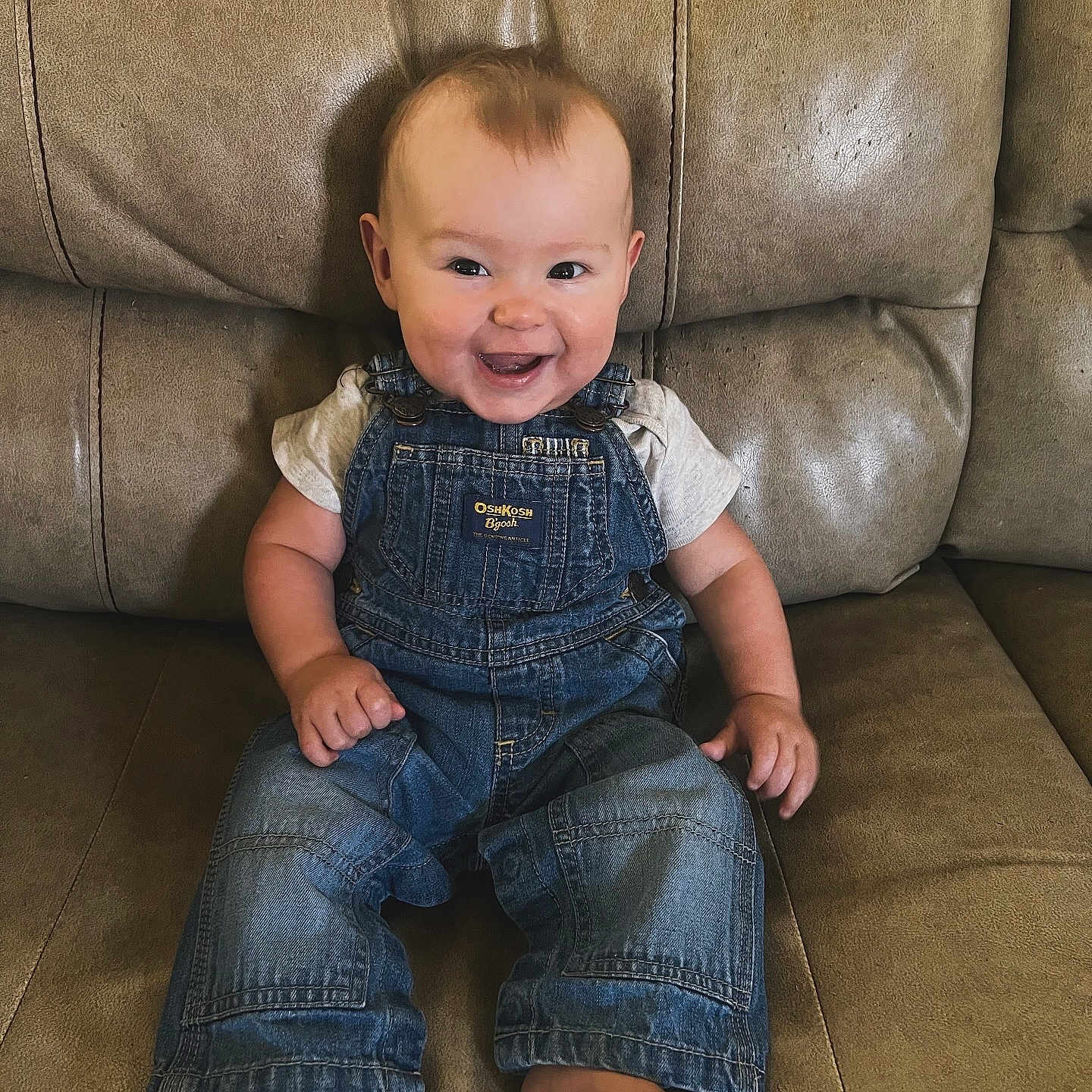 Sawyer joined the competition — help win amazing prizes! baby, babylaughing, clothing, couch, cushion, dress, face, furniture, happy, head, homedecor, jeans, laughing, pants, person, photography, portrait, sitting, smile, vest