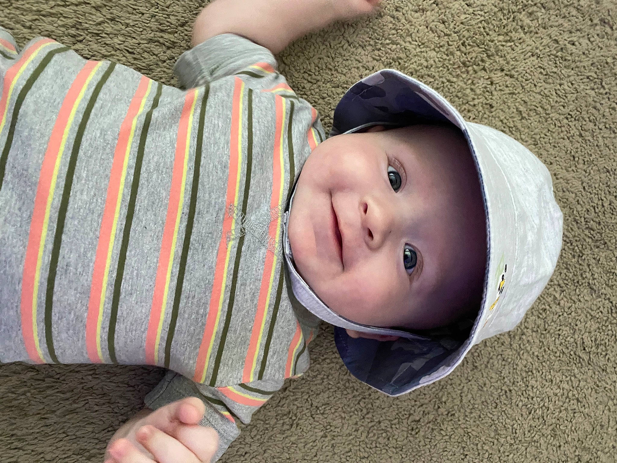 Aydan is registered to the contest to win money with this photo: baby, baby_toddler_clothing, cap, child, comfort, face, grass, hat, headwear, human_body, lip, nose, outerwear, pattern, person, plaid, skin, sleeve, smile, toddler