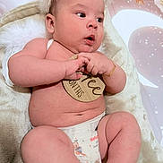 Jeremy joined the competition — help win amazing prizes! baby, infant, diaper, blanket, fur_hat, milestone_disc, bracelet, chubby_legs, cute_expression, face, eyes, hands, feet, soft_texture, nursery_background, plush, skin, portrait, lying_down, newborn