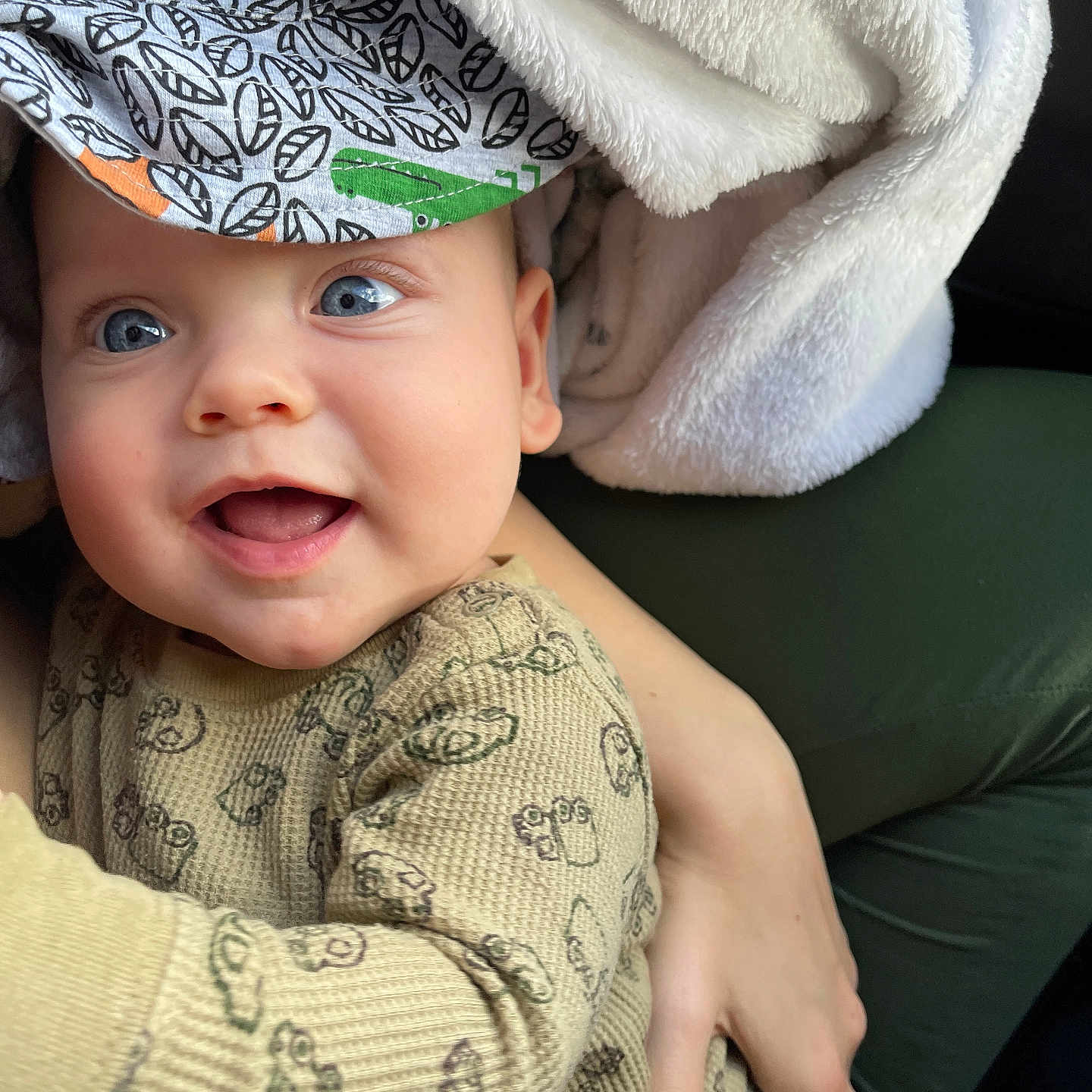 Levi is registered to the contest to win money with this photo: baby, blanket, bodypart, cap, clothing, couch, face, finger, furniture, hand, happy, hat, head, homedecor, knitwear, person, photography, portrait, smile, sweater