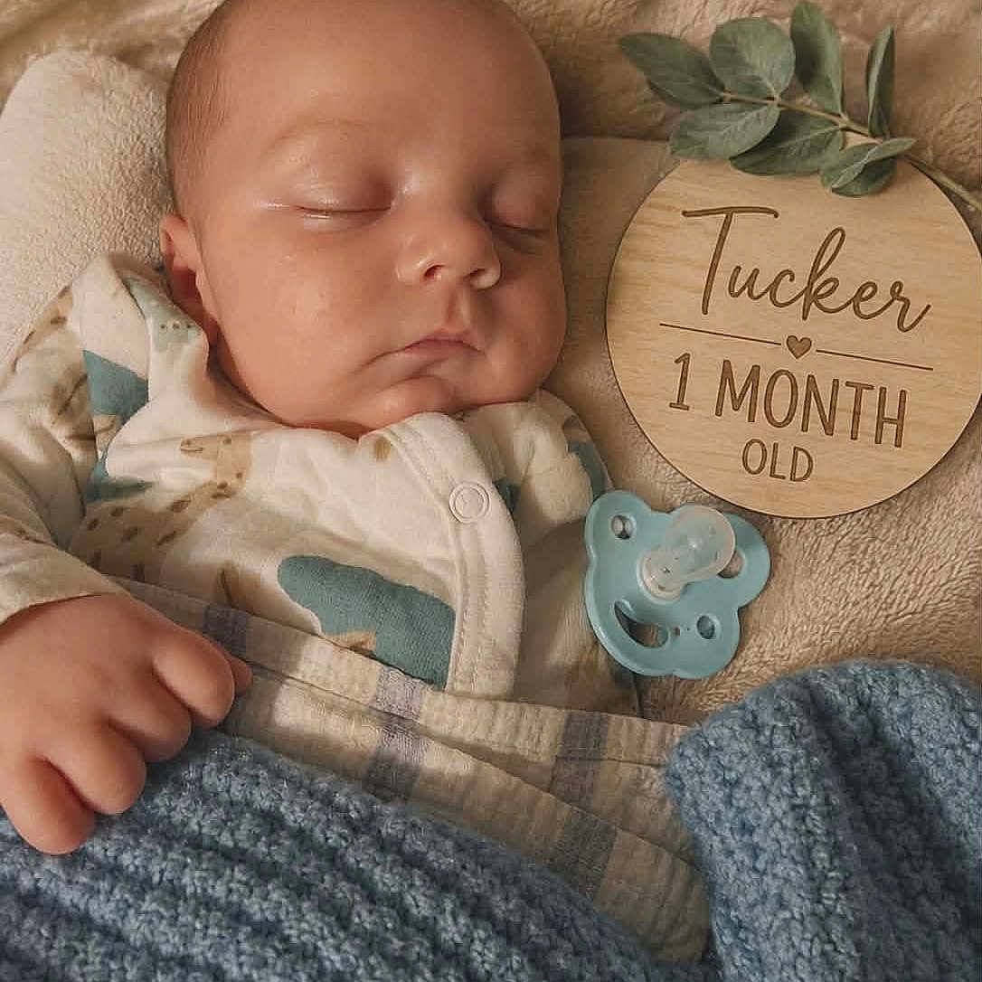 Tucker joined the competition — help win amazing prizes! baby, sleeping, blanket, pacifier, wooden_plaque, infant, cozy, cute, newborn, child, face, hand, soft, bed, clothing, blue_blanket, resting, indoor, portrait, peaceful