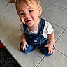 Aria is registered to the contest to win money with this photo: toddler, child, baby, smiling, happy, portrait, face, pigtails, blonde_hair, denim_overalls, white_shirt, earring, kneeling, indoor, kitchen, tile_floor, rug, fashion, cute, photography