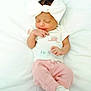 baby, newborn, infant, sleeping, white_bow, pink_pants, white_shirt, cute, peaceful, soft_blanket, lying_down, small_hands, closed_eyes, indoors, portrait, child, adorable, sleep, baby_clothes, headwear