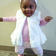 Sariah joined the competition — help win amazing prizes! toddler, child, girl, smiling, indoor, white_vest, pink_clothing, headband, boots, happy, standing, floor, wall, cute, portrait, baby, person, fashion, apparel, playful