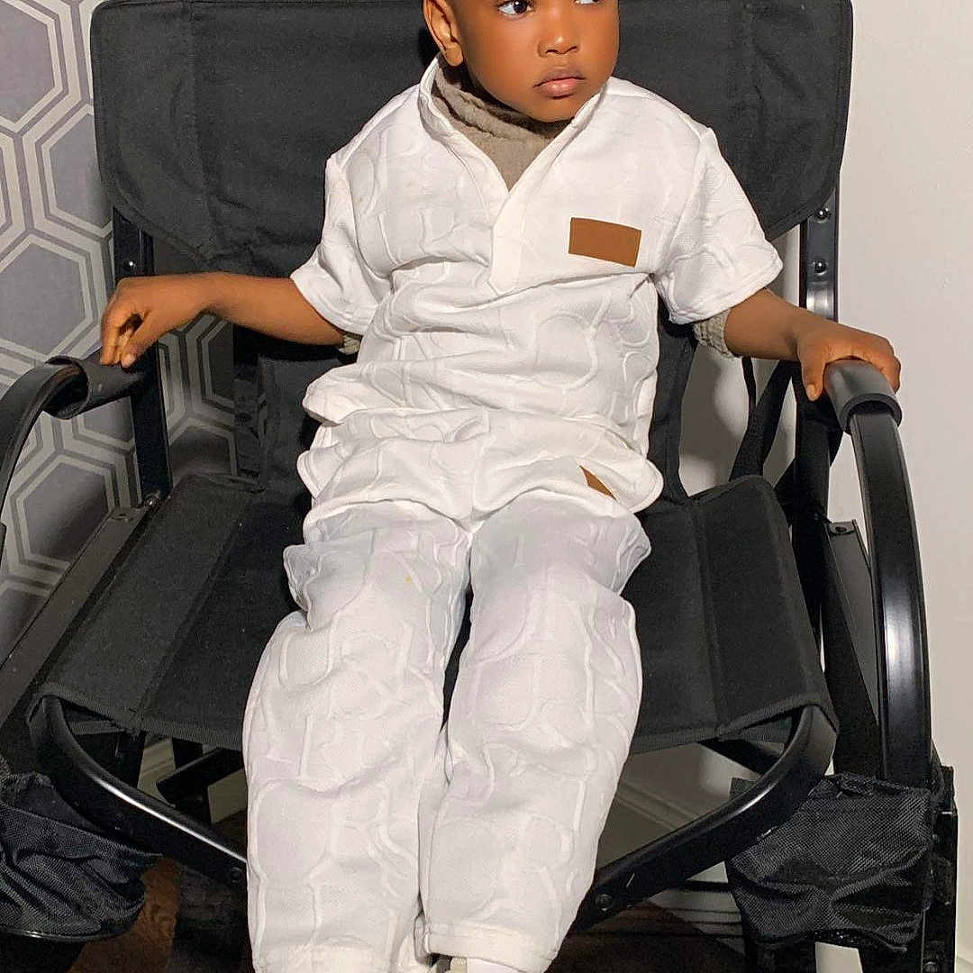 David joined the competition — help win amazing prizes! boy, chair, child, clothing, face, footwear, furniture, head, jeans, male, pants, person, photography, portrait, shoe, sitting, sleeve, sneaker, standing, student