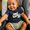 baby, child, smiling, car_seat, tshirt, nike_air, shorts, socks, happy, portrait, indoor, seatbelt, infant, cute, skin, person, one_person, sitting, clothing, young_child