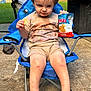 Baylen is registered to the contest to win money with this photo: barefoot, blue_chair, chair, child, concrete, daylight, expression, grass, knee_injuries, outdoor, person, playful, pool_fence, potato_chips, scrapes, shorts, snack, summer, toddler, tshirt