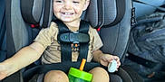 Baylen is registered to the contest to win money with this photo: baby, car_interior, car_seat, casual, child, clothing, drink, foot, hand, happy, person, seat, seat_belt, seat_belt_harness, sippy_cup, smiling, toddler, toy, transportation, young_child