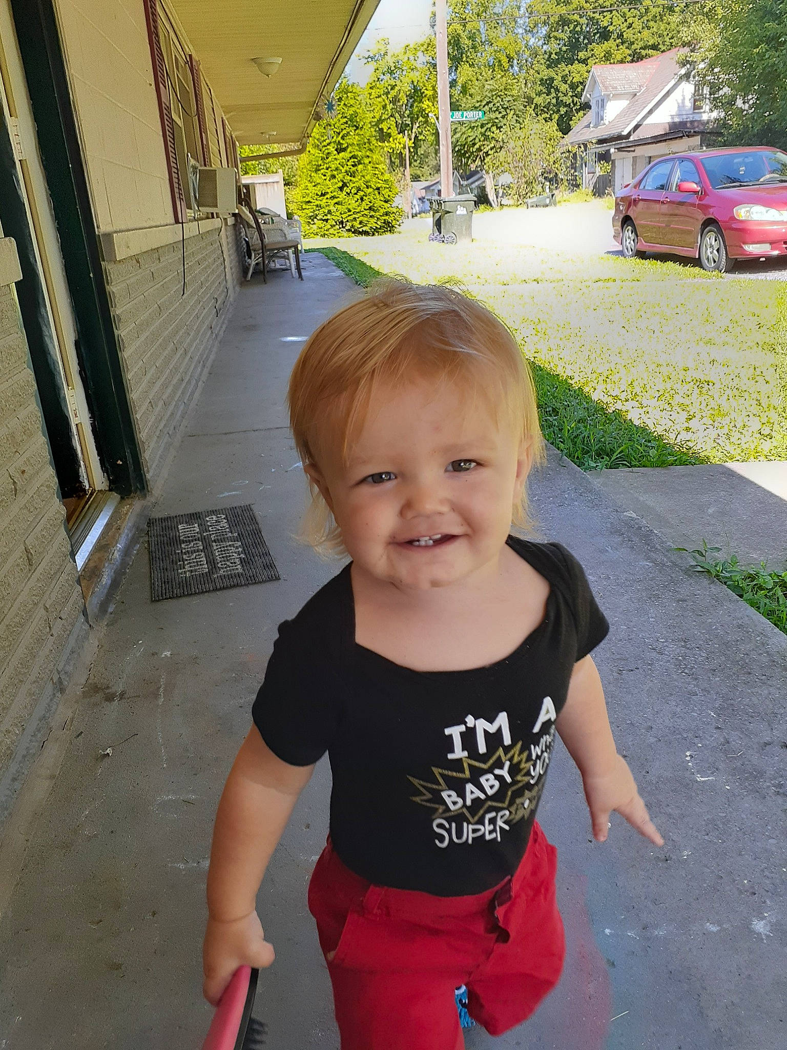 Xavier is registered to the contest to win money with this photo: asphalt, automotive_window_part, car, child, door, family_car, joy, luxury_vehicle, person, pink, smile, standing, summer, t_shirt, toddler, vacation, vehicle, vehicle_door