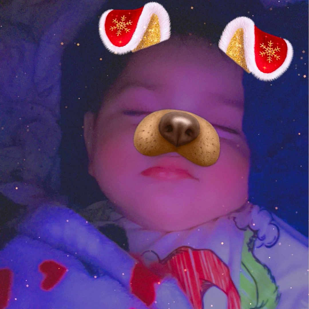 Daniel is registered to the contest to win money with this photo: baby, blanket, child, cozy, cute, dog_filter, ears, face_filter, fun, holiday, indoors, nose, pajamas, portrait, rest, sleeping, smile, soft_lighting, sparkles, warm