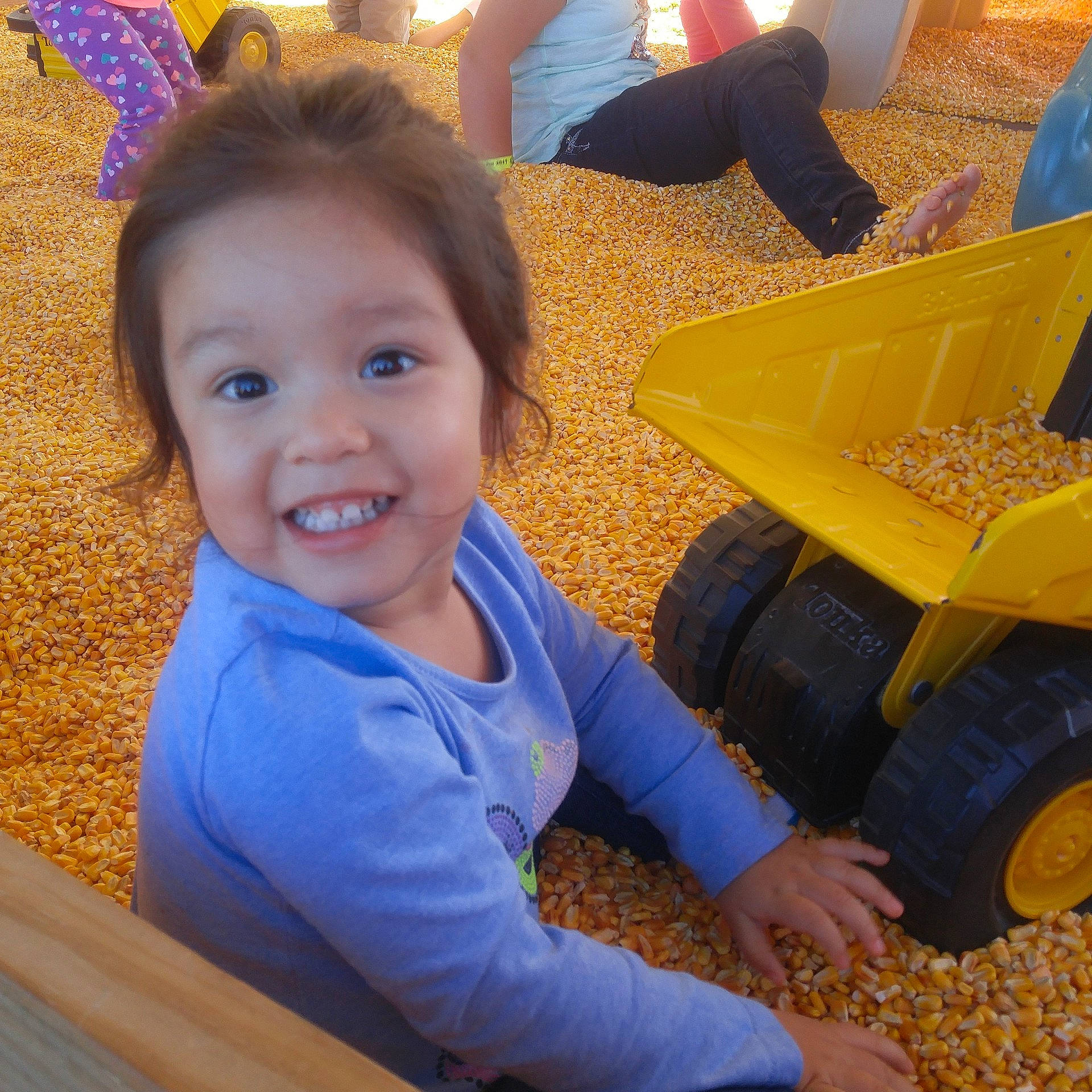 Emma is registered to the contest to win money with this photo: child, day, fun, girl, happiness, infant, iris, joy, person, play, product, sitting, smile, toddler, toy, yellow