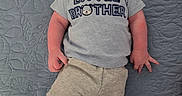 Kenneth joined the competition — help win amazing prizes! baby, infant, smiling, child, tshirt, little_brother, lying_down, quilt, blue, texture, cute, happy, portrait, person, skin, shorts, casual, indoors, young, baby_boy