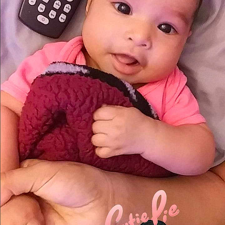 Aryanna is registered to the contest to win money with this photo: black_hair, cheek, child, daughter, day, eye, finger, girl, head, infant, iris, nose, person, pink, product, skin, smile, toddler
