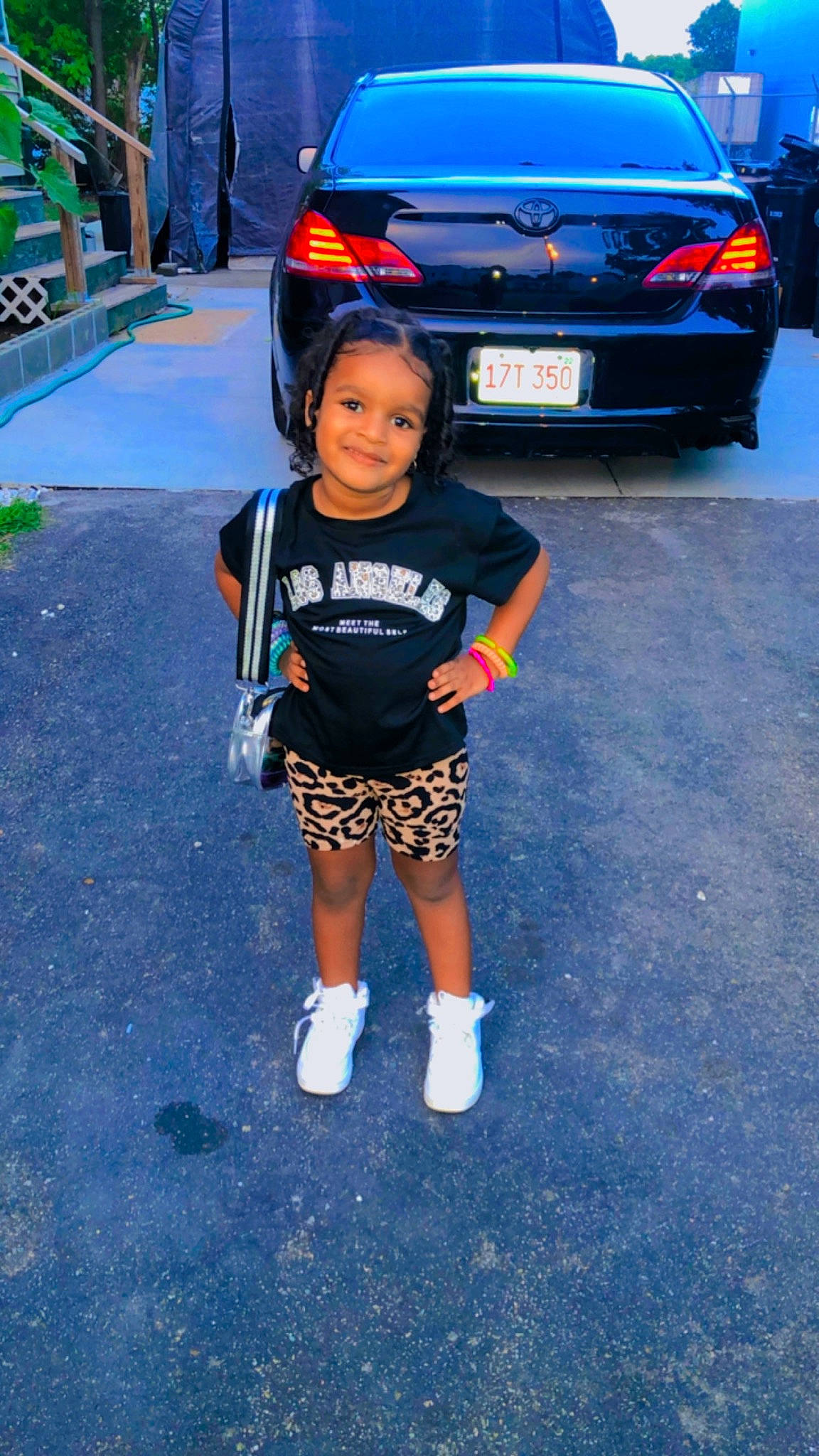 Cyara is registered to the contest to win money with this photo: asphalt, automotive_design, automotive_exterior, automotive_lighting, automotive_tire, automotive_wheel_system, blue, bumper, car, electric_blue, headwear, joy, motor_vehicle, person, personal_luxury_car, rim, shorts, tire, toddler, trunk