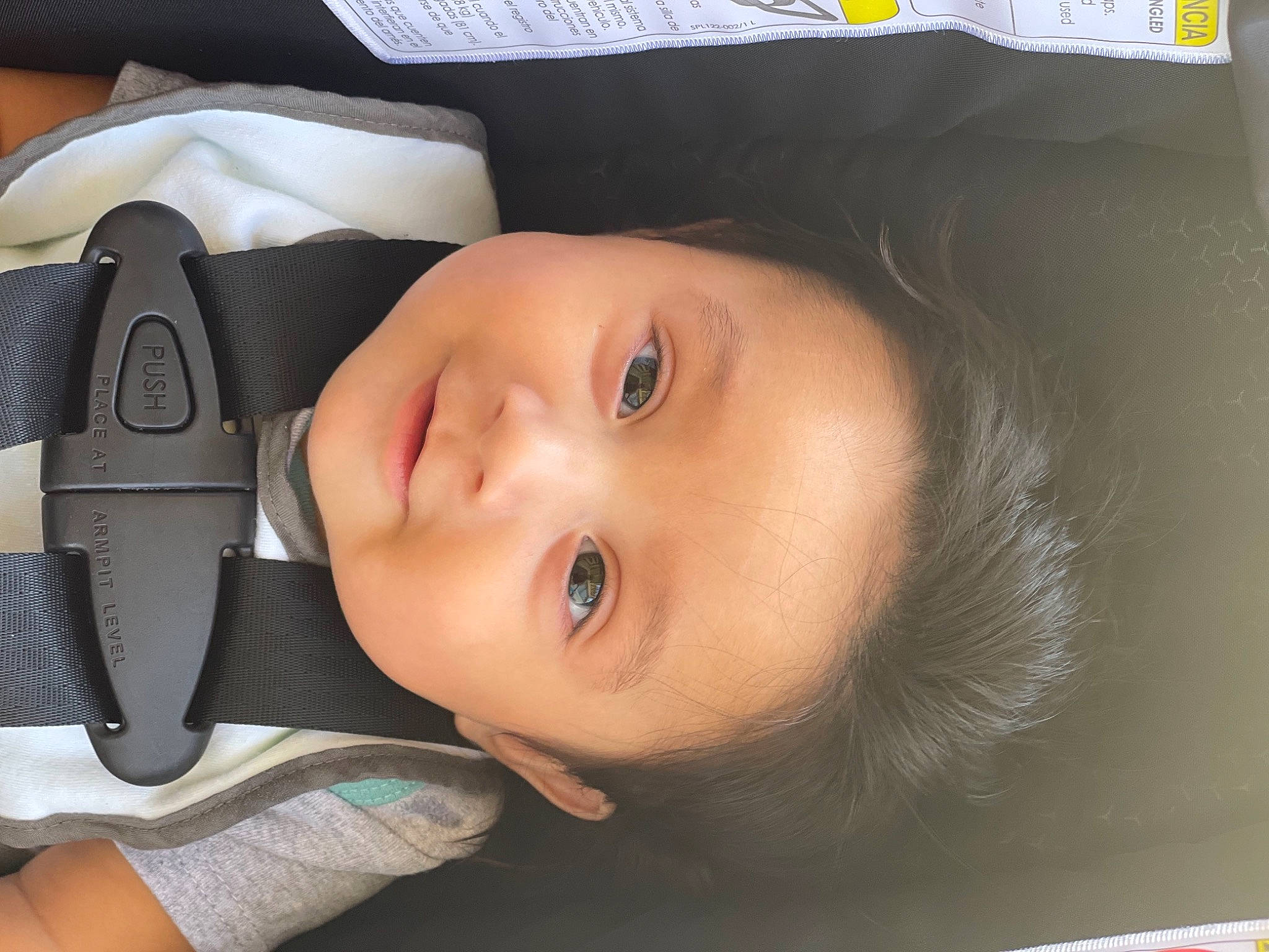 Zion is registered to the contest to win money with this photo: auto_part, baby, baby_products, baby_toddler_clothing, car_seat, cheek, child, chin, eyebrow, eyelash, flash_photography, headgear, hearing, iris, lip, nose, person, skin, smile, steering_wheel