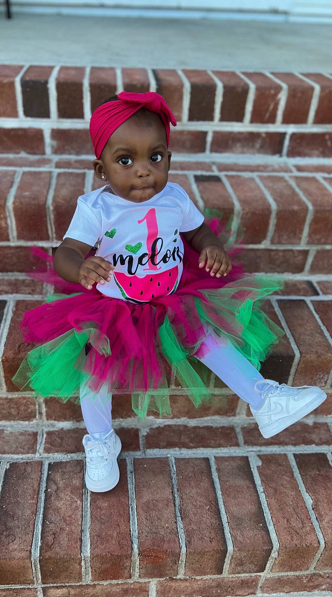 La Myah is registered to the contest to win money with this photo: baby, baby_toddler_clothing, brick, brickwork, cap, child, fashion_accessory, fun, grass, happy, headgear, leisure, magenta, person, pink, purple, sitting, smile, t_shirt, toddler