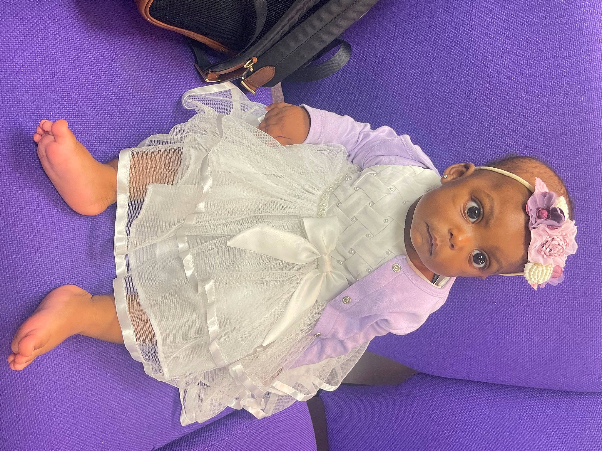La Myah is registered to the contest to win money with this photo: abdomen, baby, baby_products, baby_toddler_clothing, bag, chest, child, comfort, electric_blue, fashion_accessory, human_body, luggage_and_bags, magenta, person, pink, purple, room, textile, thigh, toddler