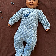Rugvednandan joined the competition — help win amazing prizes! baby, blanket, blue, blueberries, brown, child, cozy, cute, dinosaur, face, happy, indoor, infant, little_dude, lying_down, onesie, person, smile, soft_texture, text