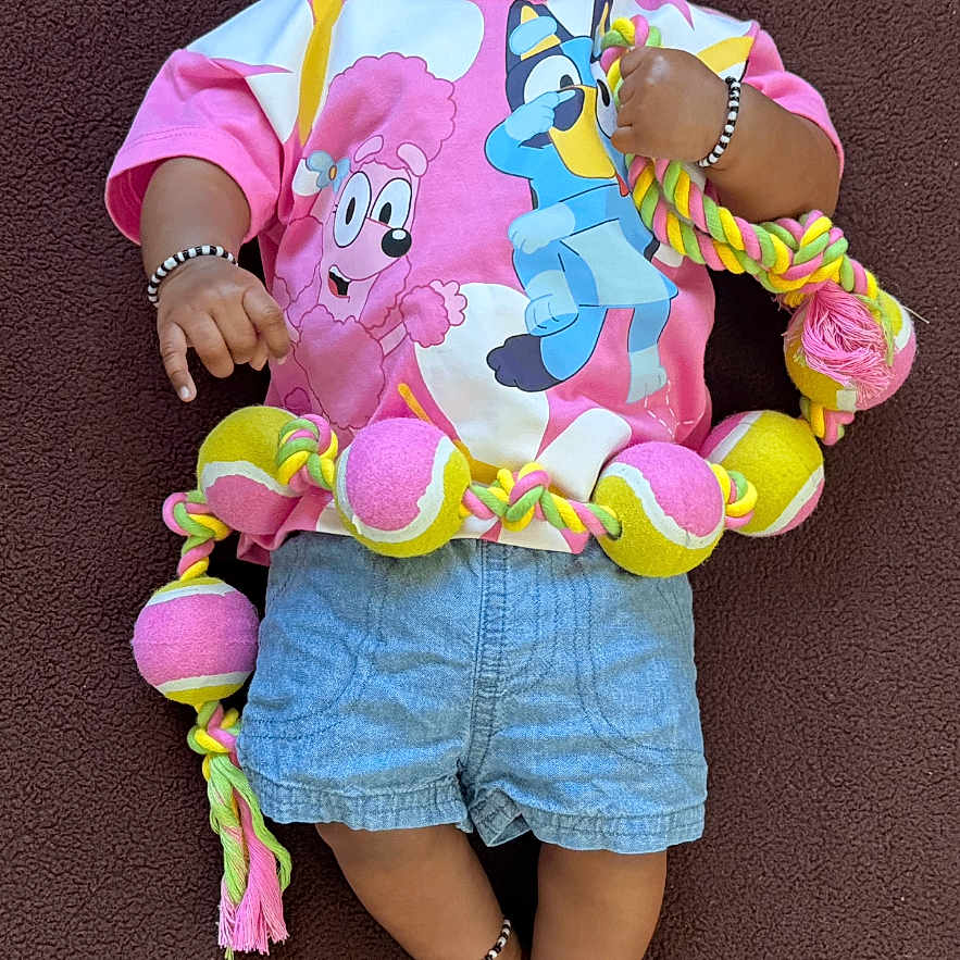 Rugvednandan is registered to the contest to win money with this photo: anklet, baby, blanket, bracelet, child, colorful, cute, denim_shorts, eyes_open, face, hair, infant, lying_down, portrait, rope_toy, skin, smiling, tennis_balls, toy, tshirt