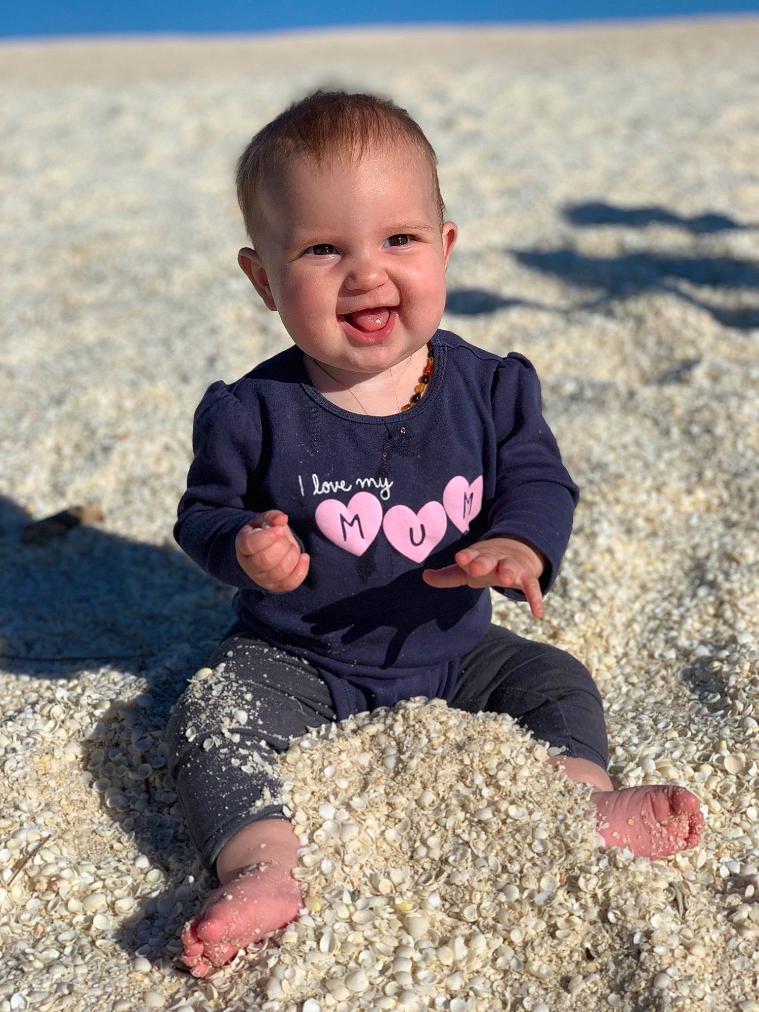 Franchesca is registered to the contest to win money with this photo: baby, beach, child, facial_expression, fun, happy, head, joy, person, photograph, photography, pink, play, rock, sand, sea, sitting, skin, smile, summer