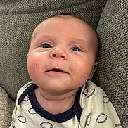 Cade is registered to the contest to win money with this photo: baby, clothing, couch, cushion, face, frown, furniture, happy, hat, head, homedecor, knitwear, newborn, pants, person, photography, portrait, smile, sweater, t_shirt
