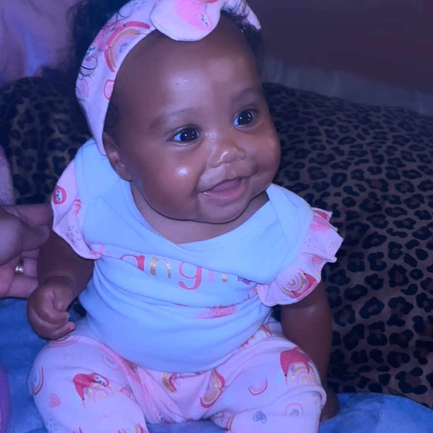 Kehlani joined the competition — help win amazing prizes! baby, babylaughing, bodypart, clothing, couch, electronics, face, finger, furniture, hand, happy, hat, head, newborn, pajamas, person, phone, photography, portrait, smile