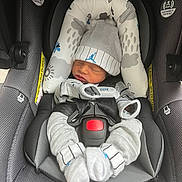Ashton joined the competition — help win amazing prizes! newborn, baby, car_seat, hat, clothing, sleeping, infant, seat_belt, safety, fabric, cushion, pattern, grey, small_hands, cute, resting, indoors, comfort, child, bundle