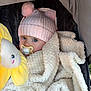 Paisley joined the competition — help win amazing prizes! baby, blanket, pink_hat, pacifier, toy, flower_toy, child, cute, warm, soft_texture, indoor, portrait, infant, cozy, headwear, blue_eyes, comfort, closeup, adorable, bundle
