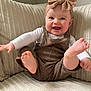 Paisley is registered to the contest to win money with this photo: baby, child, smiling, headband, bow, overalls, knitted, couch, indoor, happy, feet, tongue, playful, person, infant, cute, clothing, fabric, portrait, sitting