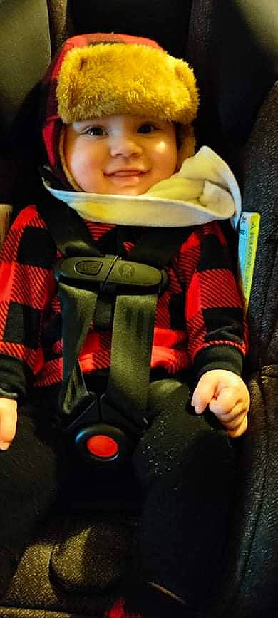 Otis is registered to the contest to win money with this photo: baby, baby_carriage, baby_safety, baby_toddler_clothing, car_seat, cheek, child, comfort, face, finger, fun, happy, headwear, joy, orange, outerwear, person, personal_protective_equipment, product, seat_belt