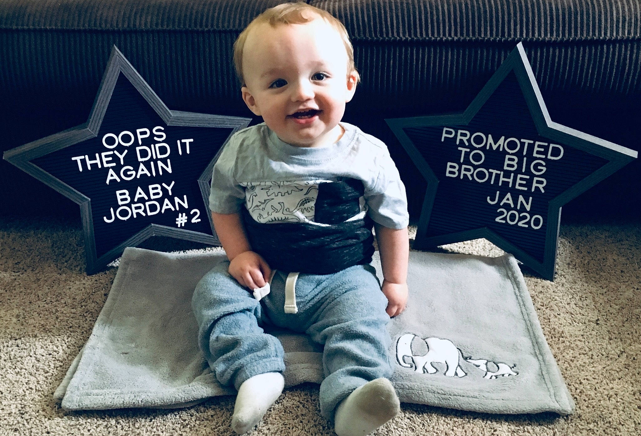 Julien Anthony is registered to the contest to win money with this photo: baby, child, cool, person, photo_caption, play, shirt, shoe, sitting, sleeve, smile, t_shirt, toddler, top