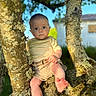 Maylann participe au concours pour gagner de l'argent avec cette photo : baby, branch, child, clothing, cute, daylight, expression, face, feet, greenery, moss, nature, outdoor, person, portrait, shirt, shorts, sunlight, tree, young