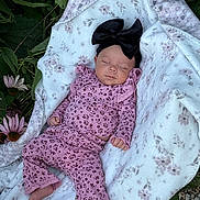 Laylani Dailynn joined the competition — help win amazing prizes! baby, sleeping, infant, blanket, headband, pink_clothing, flower_pattern, outdoor, nature, leaves, flowers, soft_texture, peaceful, newborn, cute, portrait, child, resting, cozy, babywear