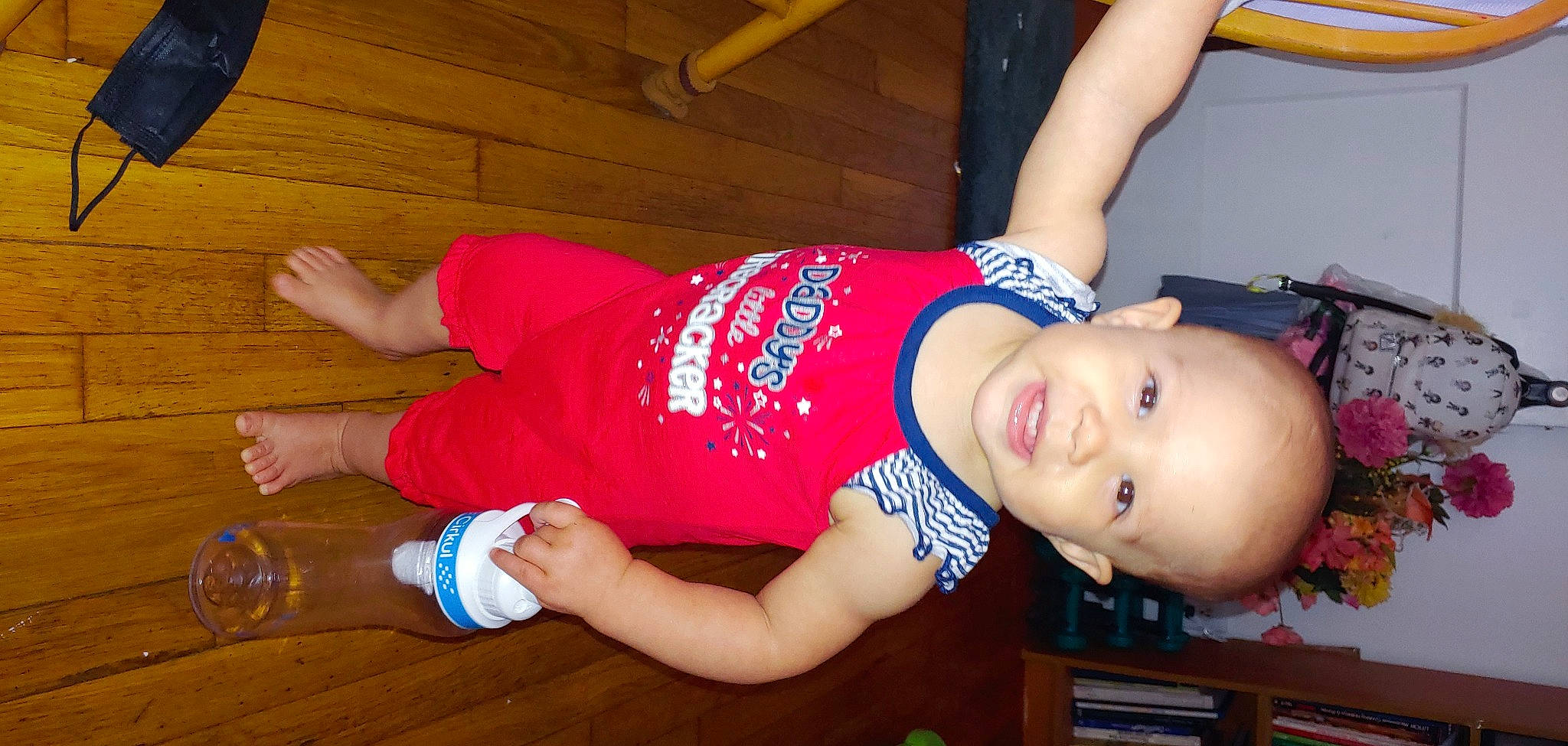 Marlie is registered to the contest to win money with this photo: abdomen, arm, baby_toddler_clothing, chest, elbow, flooring, fun, hand, hat, human_leg, joint, knee, orange, person, shorts, sportswear, thigh, toddler, trunk, waist