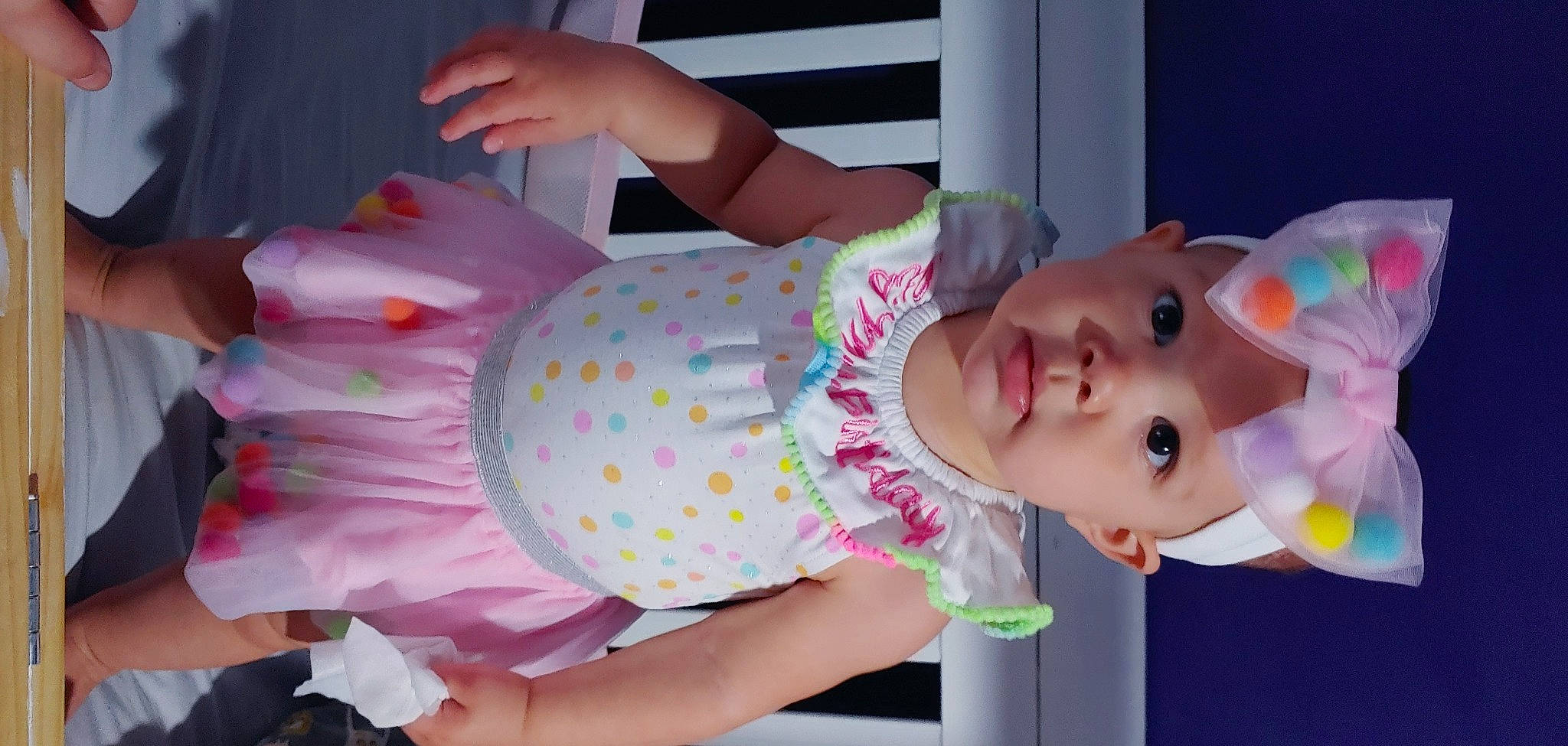 Marlie is registered to the contest to win money with this photo: arm, baby, baby_products, baby_toddler_clothing, child, event, fun, happy, headwear, leisure, magenta, pattern, peach, person, pink, product, room, skin, textile, toddler