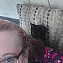 Prince Louie is registered to the contest to win money with this photo: animal, black_cat, casual, cat, closeup, couch, cozy, fabric, face, glasses, hair, home, indoor, partial_face, patterned_pillow, person, pet, pillow, resting, wall