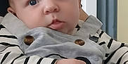 Liam a rejoint le concours — aidez-le/la à gagner de superbes lots ! baby, infant, child, face, portrait, eyes, hand, clothing, striped_shirt, overalls, adult_arm, skin, indoor, person, cute, expression, closeup, holding, soft_light, blurred_background