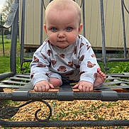 Raymond is registered to the contest to win money with this photo: baby, child, outdoor, bench, metal_bench, gravel, grass, garden, building, face, blue_eyes, long_sleeve, clothing, barefoot, crouching, portrait, cute, expression, nature, daylight