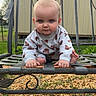 baby, child, outdoor, bench, metal_bench, gravel, grass, garden, building, face, blue_eyes, long_sleeve, clothing, barefoot, crouching, portrait, cute, expression, nature, daylight