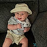 Landen is registered to the contest to win money with this photo: baby, smiling, hat, bib, pacifier, couch, clothing, shorts, tshirt, indoor, child, happy, face, person, sitting, cute, infant, hand, foot, texture