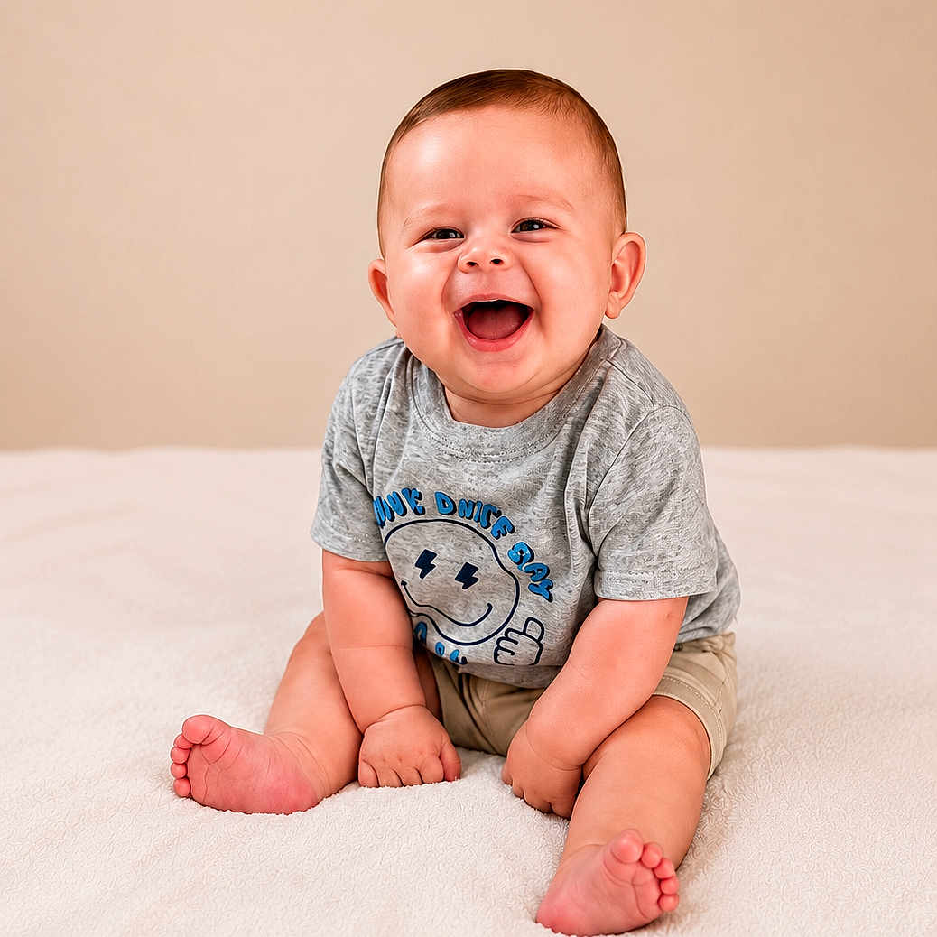 Landen joined the competition — help win amazing prizes! baby, child, smiling, happy, sitting, tshirt, shorts, barefoot, indoors, blanket, cute, infant, portrait, young_child, one_person, studio, neutral_background, joyful, casual_clothing, human
