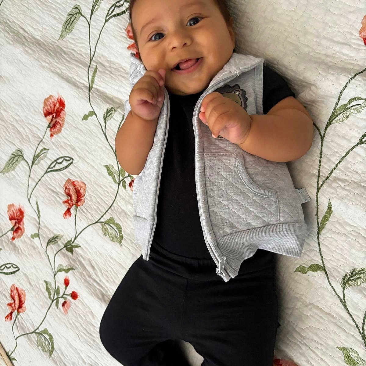 Joel joined the competition — help win amazing prizes! baby, babylaughing, blanket, clothing, coat, cushion, face, happy, head, homedecor, jeans, pants, person, photography, portrait, quilt, sitting, sleeve, smile, standing