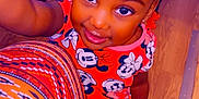 Kali joined the competition — help win amazing prizes! child, girl, smiling, braided_hair, beads, colorful_clothing, minnie_mouse, red_shirt, orange_pants, wooden_floor, indoors, selfie, cute, happy, portrait, person, bright_colors, patterned_fabric, hand, feet