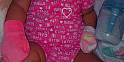 Kira is registered to the contest to win money with this photo: animal_print, baby, blanket, bottle, child, closeup, clothing, cozy, cute, indoor, infant, mittens, newborn, pacifier, peaceful, pink_onesie, portrait, resting, sleeping, soft_toys