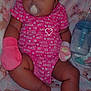 Kira is registered to the contest to win money with this photo: baby, sleeping, pacifier, pink_onesie, mittens, blanket, bottle, infant, cute, resting, soft_toys, animal_print, cozy, child, portrait, indoor, clothing, peaceful, newborn, closeup