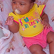 Kira joined the competition — help win amazing prizes! baby, blanket, cartoon_animals, child, clothing, cute, expression, face, hair_clip, hand, indoors, infant, pacifier, person, pink_shorts, relaxed, seated, skin, soft_texture, yellow_shirt