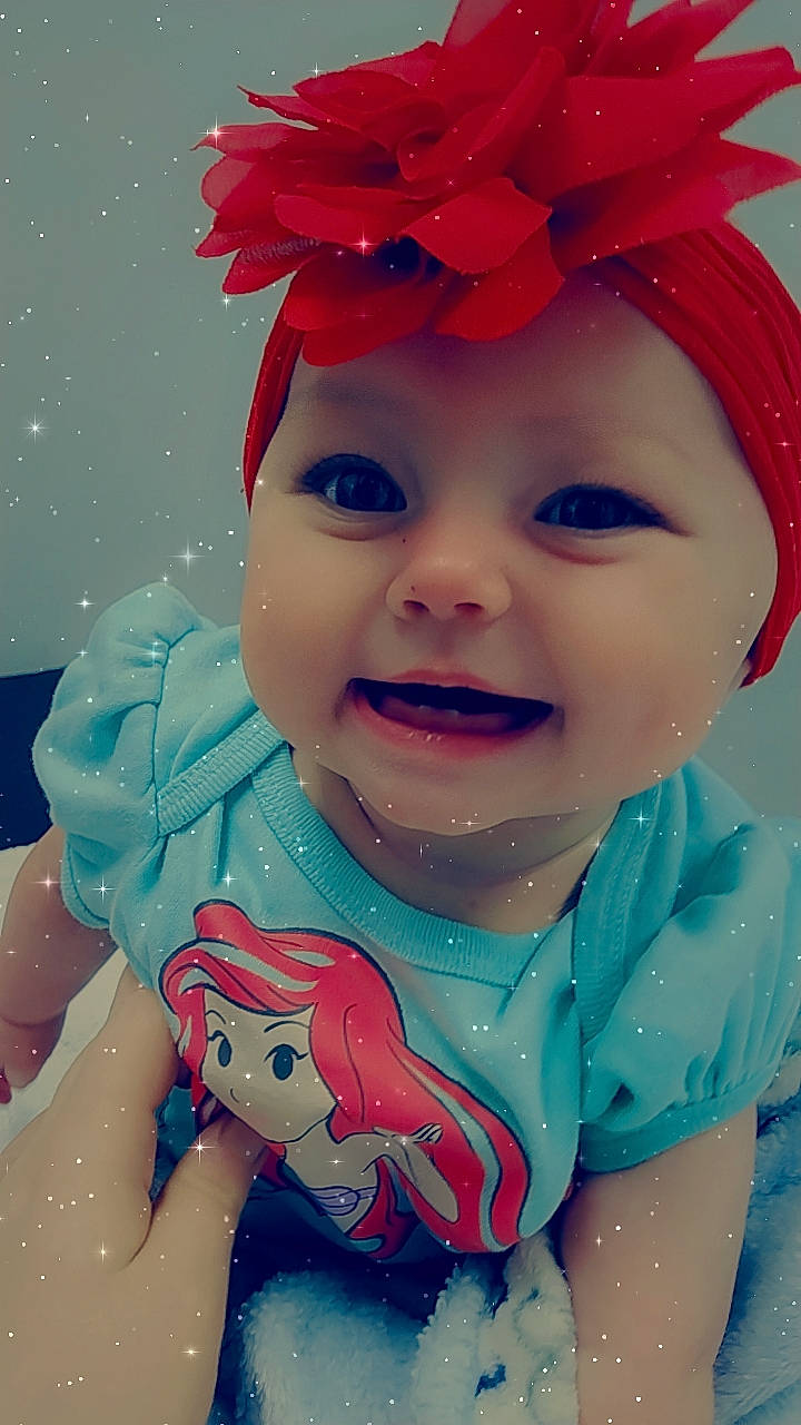 Audreya is registered to the contest to win money with this photo: baby, baby_toddler_clothing, cheek, child, chin, electric_blue, face, fun, happy, head, headpiece, headwear, human_body, joy, mouth, party_supply, person, pink, red, skin