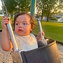 toddler, child, swing, playground, outdoor, grass, trees, metal, chain, seat, sunlight, park, daylight, curious, expression, clothing, person, nature, bench, residential