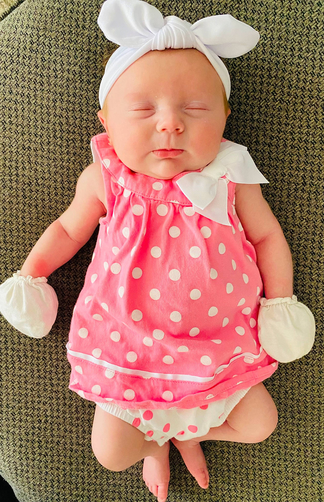 Madelyn joined the competition — help win amazing prizes! arm, baby, baby_toddler_clothing, cheek, child, clothing, dress, facial_expression, finger, gesture, hand, headwear, one_piece_garment, person, pink, product, skin, sleeve, textile, thumb