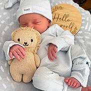 Kai joined the competition — help win amazing prizes! newborn, baby, infant, sleeping, plush_toy, knitted_lion, hat, ribbed_clothing, blanket, wooden_sign, hello_world, cozy, cute, soft, indoor, peaceful, child, hand, foot, portrait